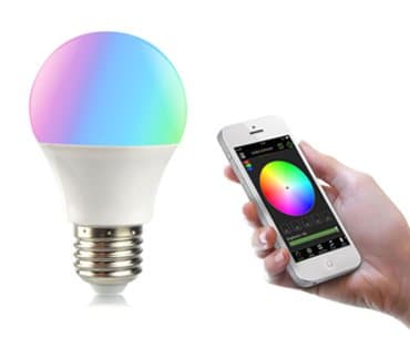 Colour-changing bulb glowing pink and blue beside a phone showing a colour wheel, shown as the SmartLight Custom Setting Mode add-on