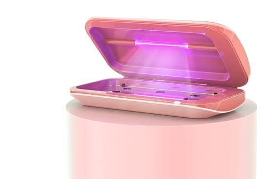 SmartSanitizer Pro pink clamshell UV box with its lid open and a purple UV bulb lit inside, on a pink stand