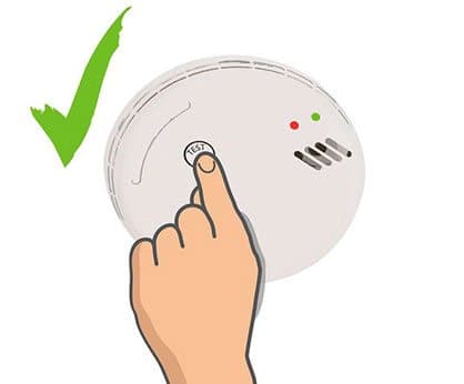 Finger pressing the test button on a white smoke alarm with red and green lights, illustrating the SmokeSOS Functional Test Button add-on