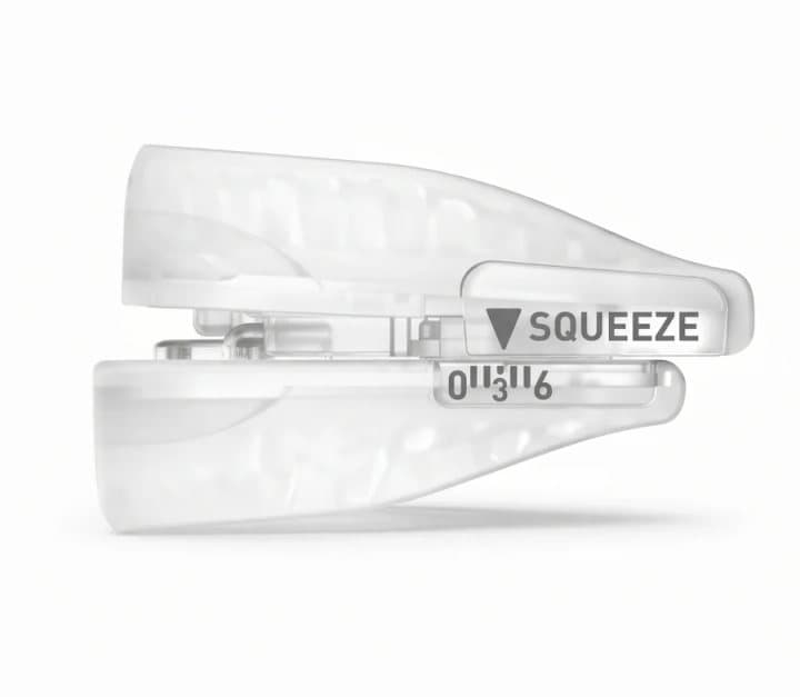 Close-up of the SnoreRX front adjuster with a squeeze marker and a numbered scale