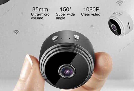 Fingers holding a small round black SpyRec Pro camera with a glossy front lens, with a white version and Wi-Fi icons behind