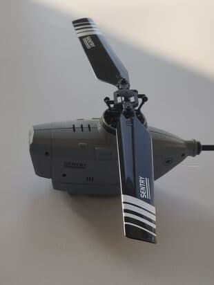 Grey StealthHawk Pro seen side-on on a white surface, with its two rotor blades marked Sentry