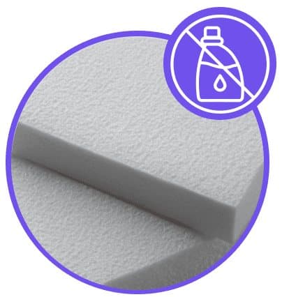 Close-up of white melamine foam sponge with a no-chemicals icon