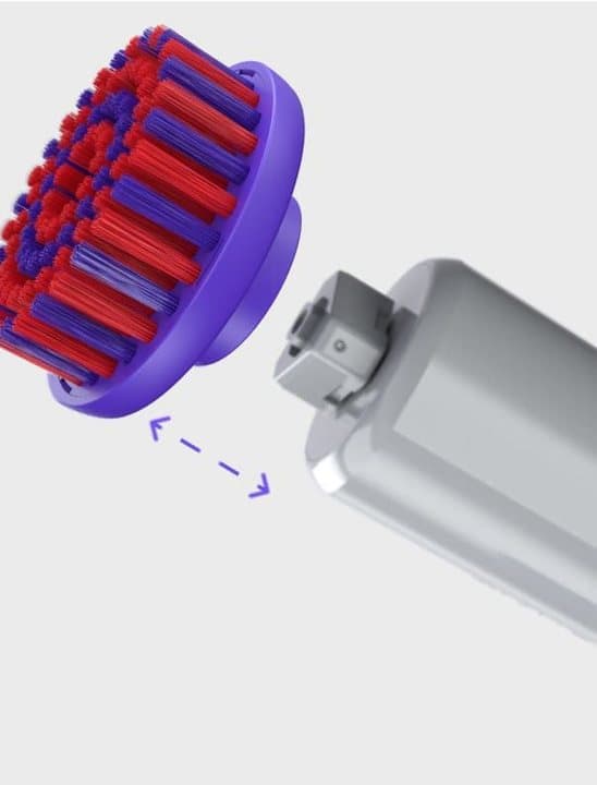 Red Synoshi brush head being fitted onto the scrubber's quick-swap connector
