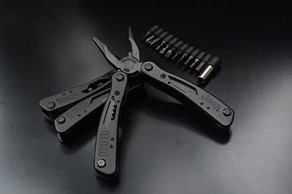 Black folding multi-tool with pliers and a row of screwdriver bits, offered as a TacticalX add-on