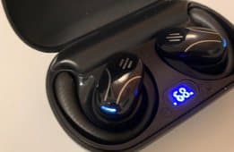 Talky AI Buds in their black charging case with a blue battery percentage display