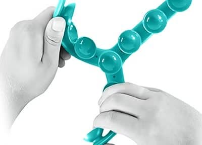 Hands bending a teal Tenikle leg covered in suction cups