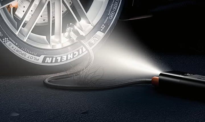 TireHero's built-in flashlight lighting up a car tire at night