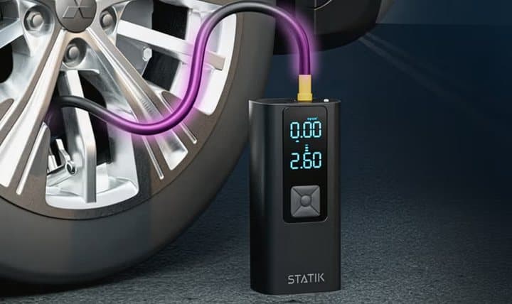 TireHero connected to a car tire valve with its display showing current and target pressure