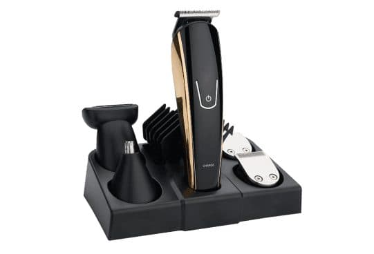 TotalTrim Pro black trimmer with a gold side panel in a three-section stand holding a foil shaver, nose trimmer, stacked guide combs and two blade heads