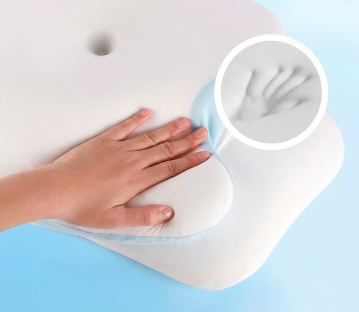 Hand pressing into the VelaSleep memory foam, leaving a handprint