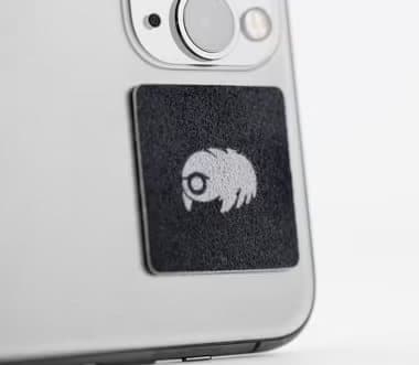 Black WaterBear patch stuck to the back of a silver phone
