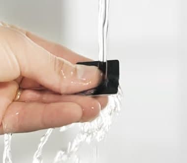Hand rinsing a WaterBear patch under a running tap
