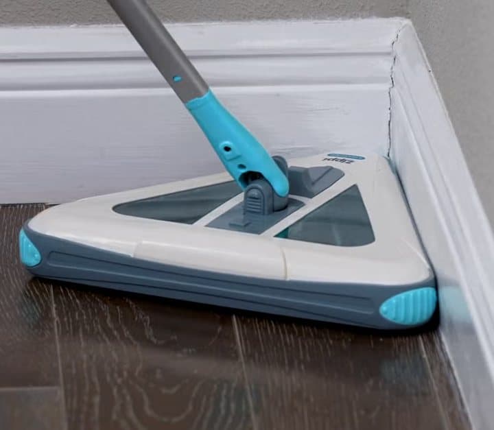 Zippi Sweeper pushed into the corner of a room along a white skirting board
