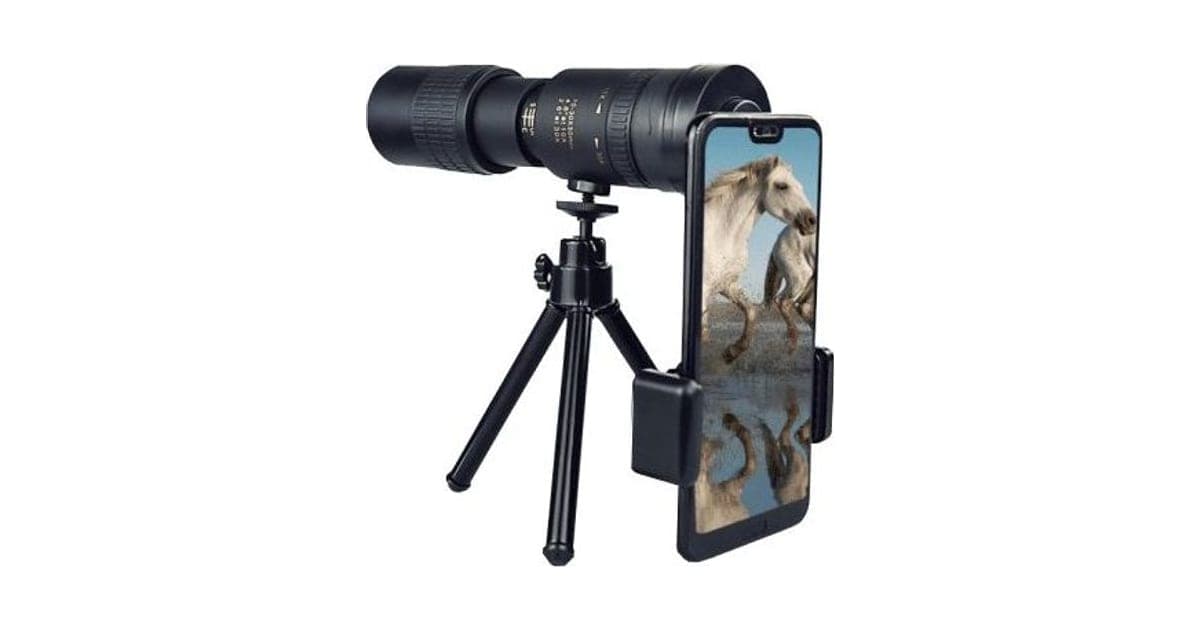 Black ZoomShot Pro monocular on a mini tripod with a phone clamped to the eyepiece showing white horses on screen