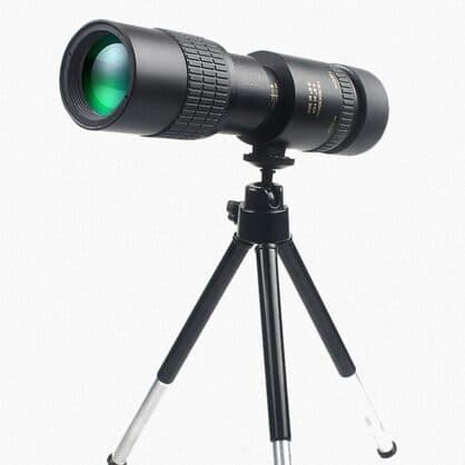 Black ZoomShot Pro monocular with a green-coated front lens on a three-legged mini tripod